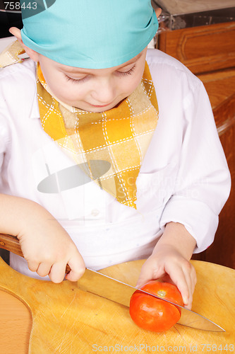 Image of Little cook with cutting tomato