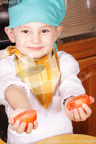 Image of Little cook with cutted tomato