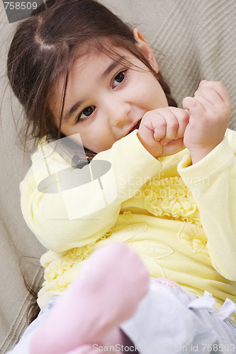 Image of Little girl on sofa with phone