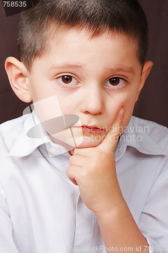 Image of Serious boy in white shirt