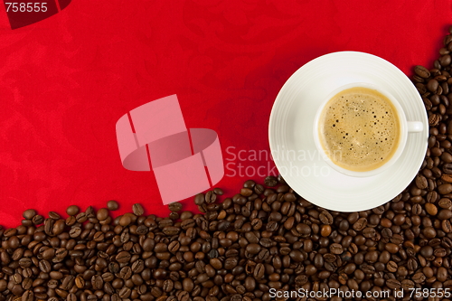 Image of coffee cup from above with coffee beans