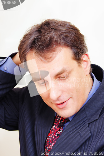 Image of Businessman scratching head