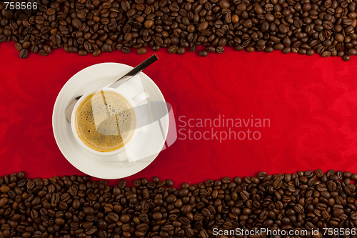 Image of coffee cup from above with coffee beans