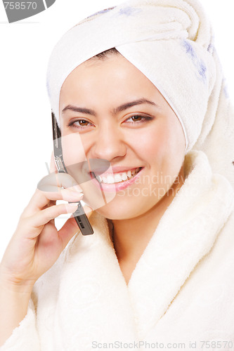 Image of Smiling woman in bathrobe with phone