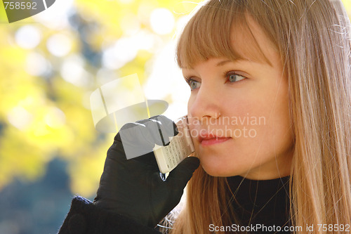 Image of Blonde with phone looks right