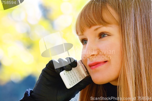 Image of Smiling blonde with phone looks right