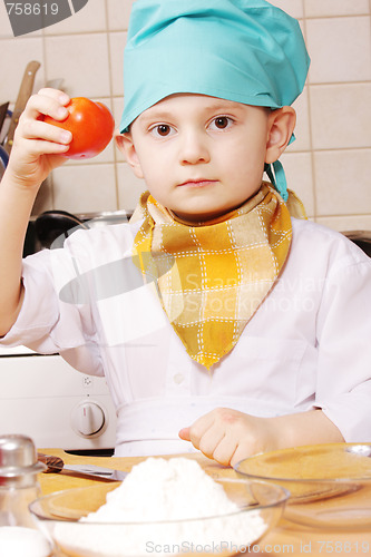 Image of Little cook with tomato