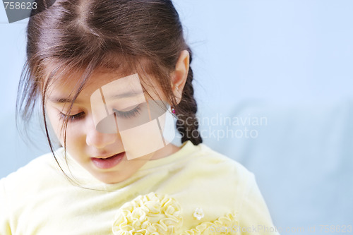 Image of Little girl looking down