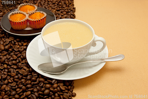 Image of White cup of coffee and coffee beans