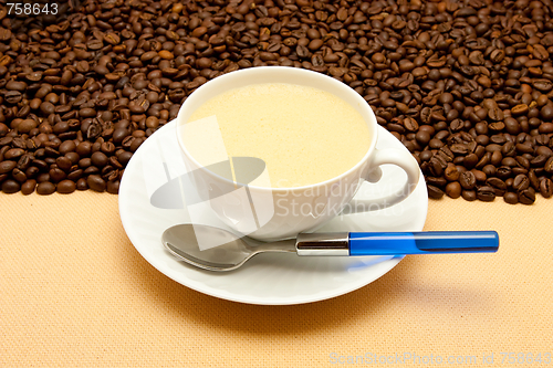 Image of White cup of coffee and coffee beans