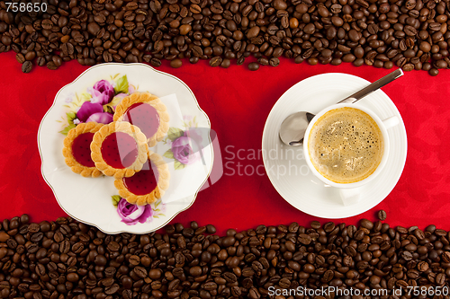 Image of coffee cup from above with coffee beans