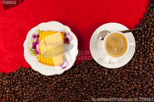 Image of coffee cup from above with coffee beans