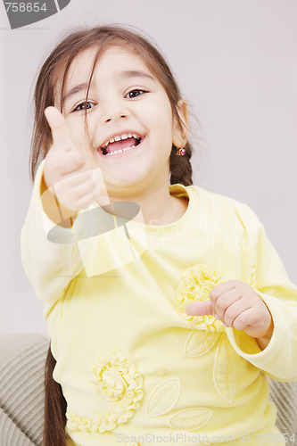 Image of Girl in yellow with thumb up