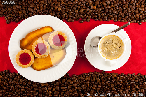 Image of coffee cup from above with coffee beans