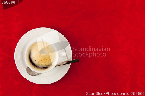 Image of white cup of coffee  on red background