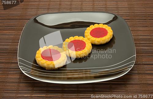 Image of plate of cookies on dark brown background