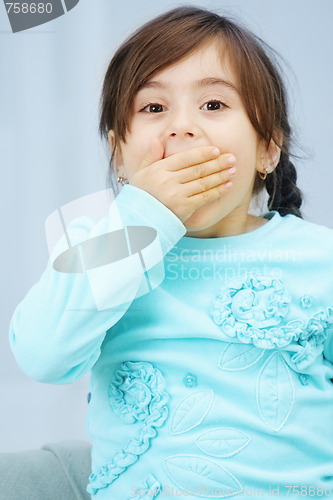 Image of Little girl closes mouth