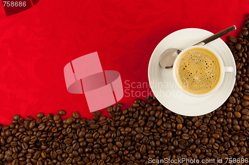 Image of coffee cup from above with coffee beans