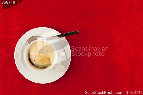 Image of white cup of coffee  on red background