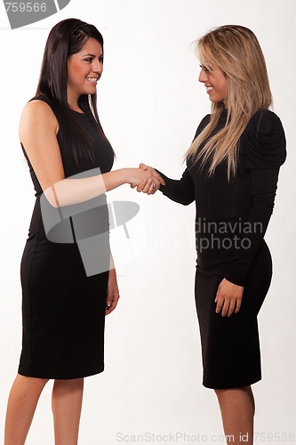 Image of Two attractive hispanic twenties businesswomen talking