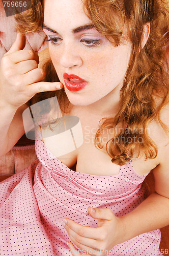 Image of Girl in dress on sofa.