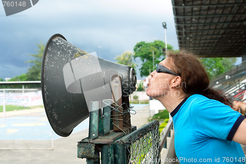 Image of Man yelling thru horn