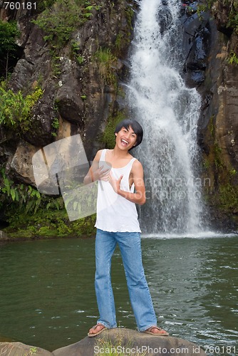 Image of Boy singing at waterfall