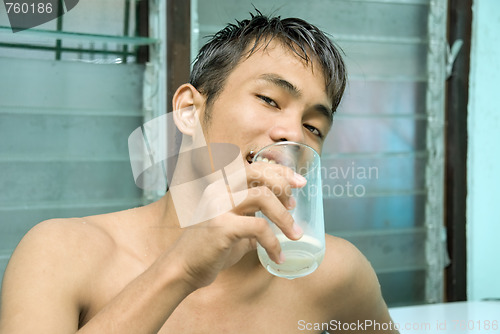 Image of Asian man drinking