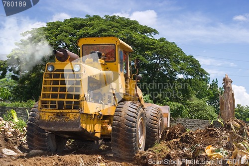 Image of Worn bulldozer on tropical terrain