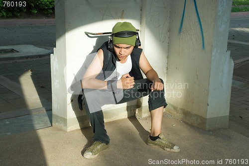 Image of Young rapper man sitting