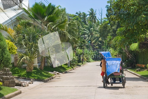 Image of Tropical suburb with tricycle