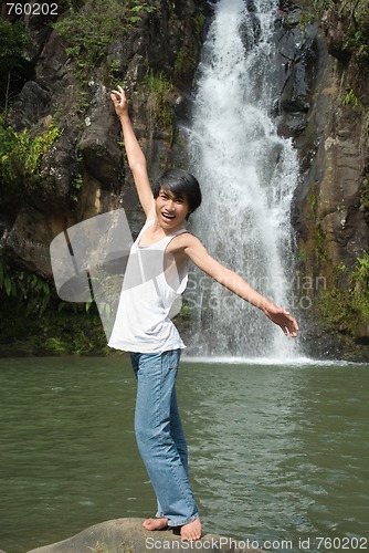 Image of Boy balancing at waterfall