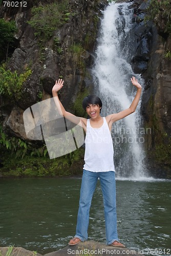 Image of Boy cheering at waterfall