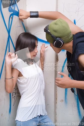 Image of Urban mugger intimidating girl