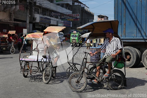 Image of Southeast-Asian tricycles on urban street