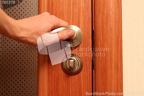 Image of The hand opening a door