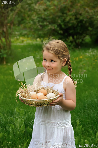 Image of Little girl holding eggs