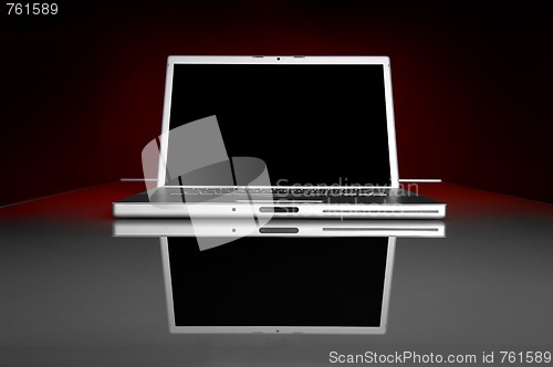 Image of High Tech Laptop on Glass table with reflection