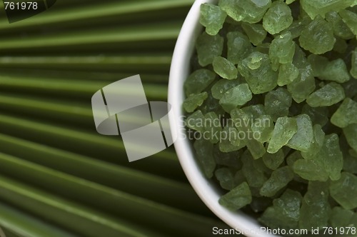 Image of bath salt and palm leaf