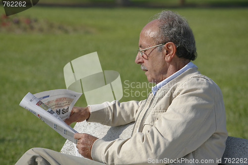 Image of Man reading newspaper