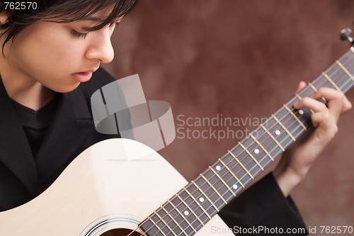 Image of Attractive Ethnic Girl Plays Guitar