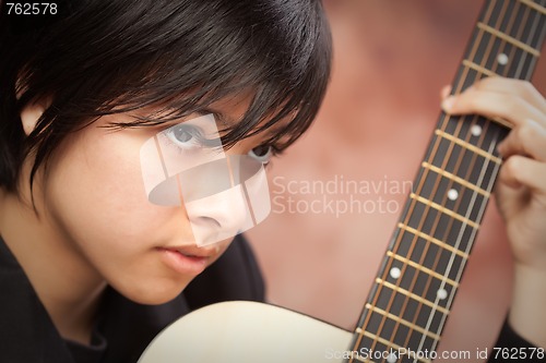 Image of Attractive Ethnic Girl Plays Guitar