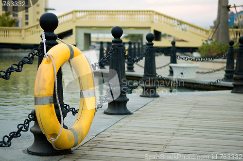 Image of Yellow life buoy on fence