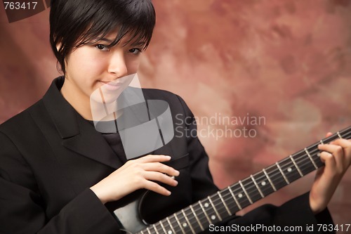 Image of Multiethnic Girl Poses with Electric Guitar