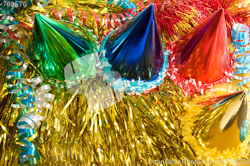 Image of Holiday background with ribbons, serpentine and colored caps