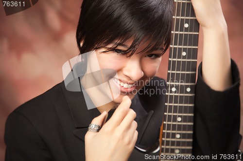 Image of Multiethnic Girl Poses with Electric Guitar