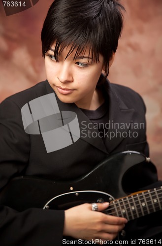 Image of Multiethnic Girl Poses with Electric Guitar