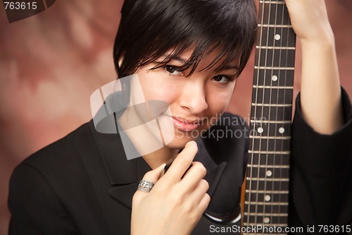 Image of Multiethnic Girl Poses with Electric Guitar