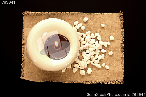 Image of candles and massage stones in a calm zen spa