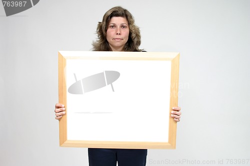 Image of Young woman holding blank board